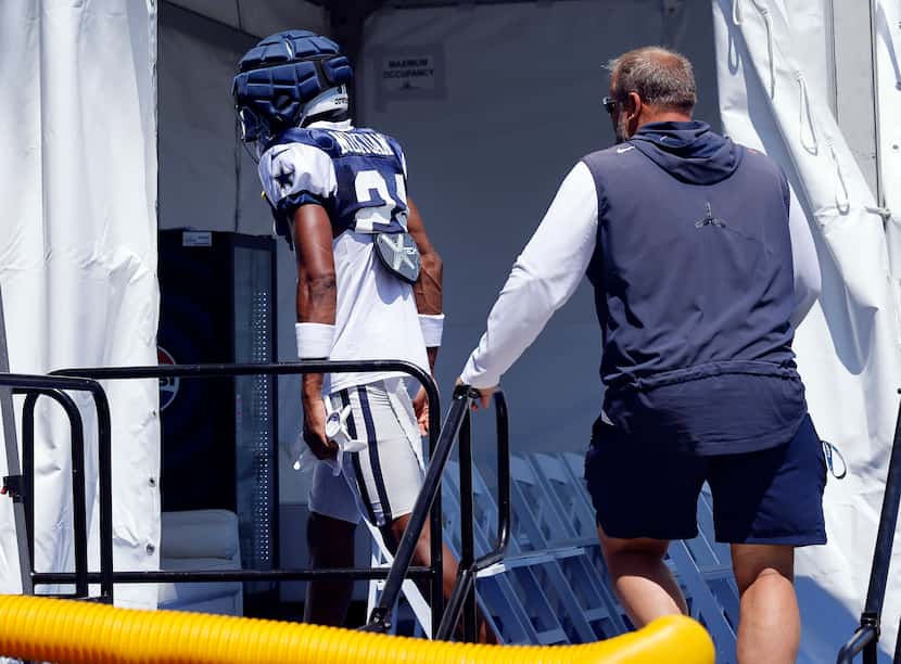 Dallas Cowboys safety Israel Mukuamu (24) leaves the field with an injury during a training...