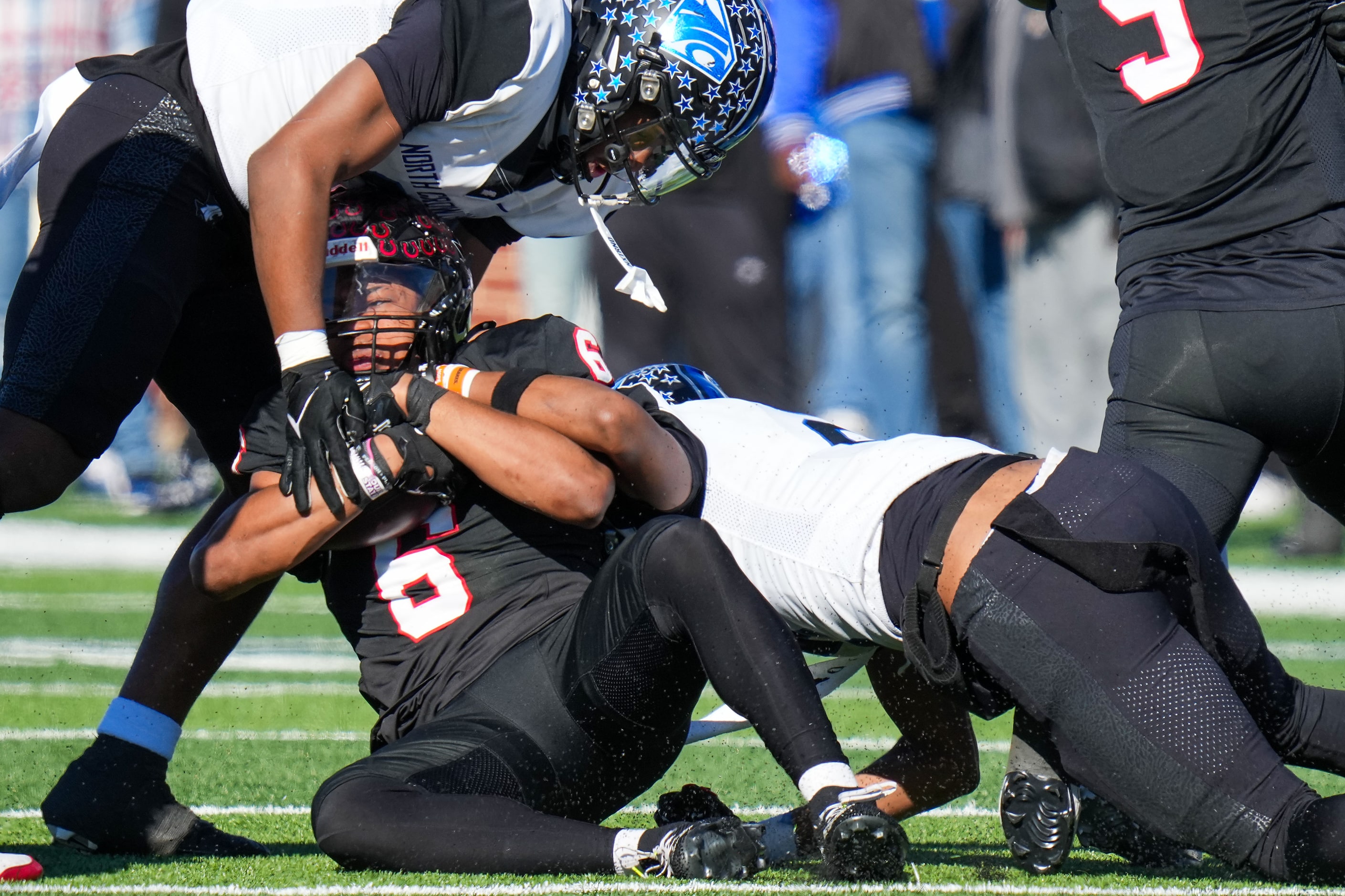 Coppell running back O'Marion Mbakwe (6) is brought down by the North Crowley defense during...