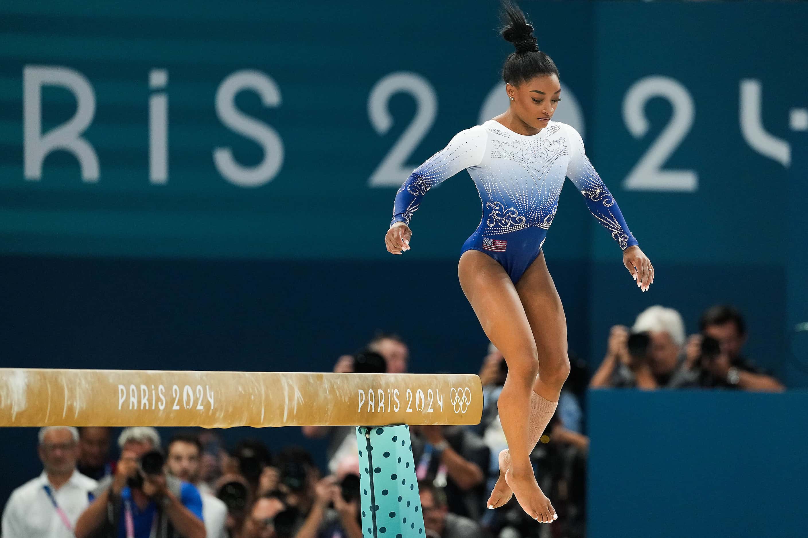 Simone Biles of the United States steps off while she competes on the balance beam during...