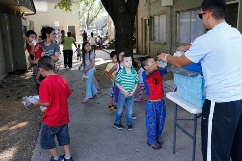 
AmeriCorps volunteer Gilbert Castillo handed out breakfast meals to children at the El Sol...