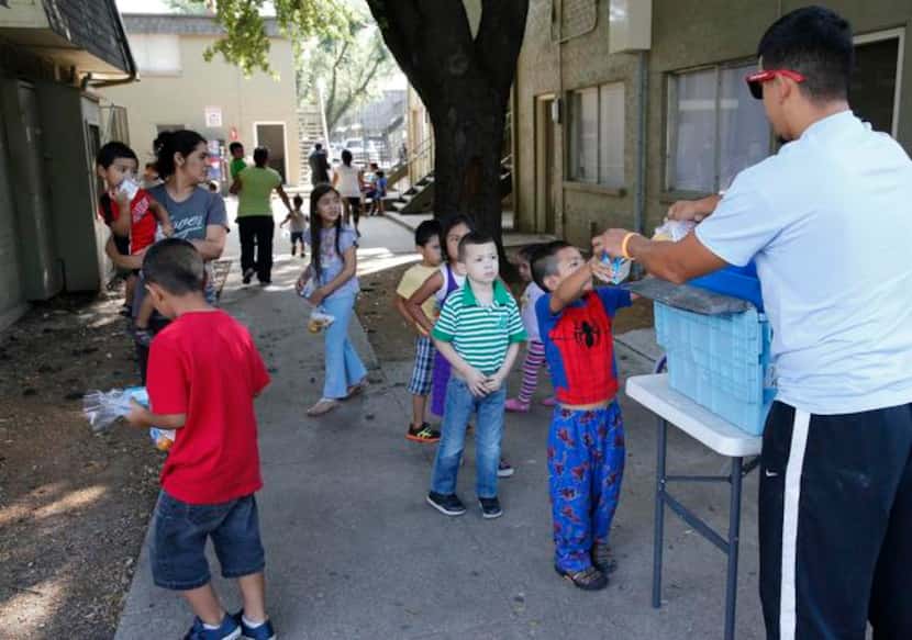 
AmeriCorps volunteer Gilbert Castillo handed out breakfast meals to children at the El Sol...