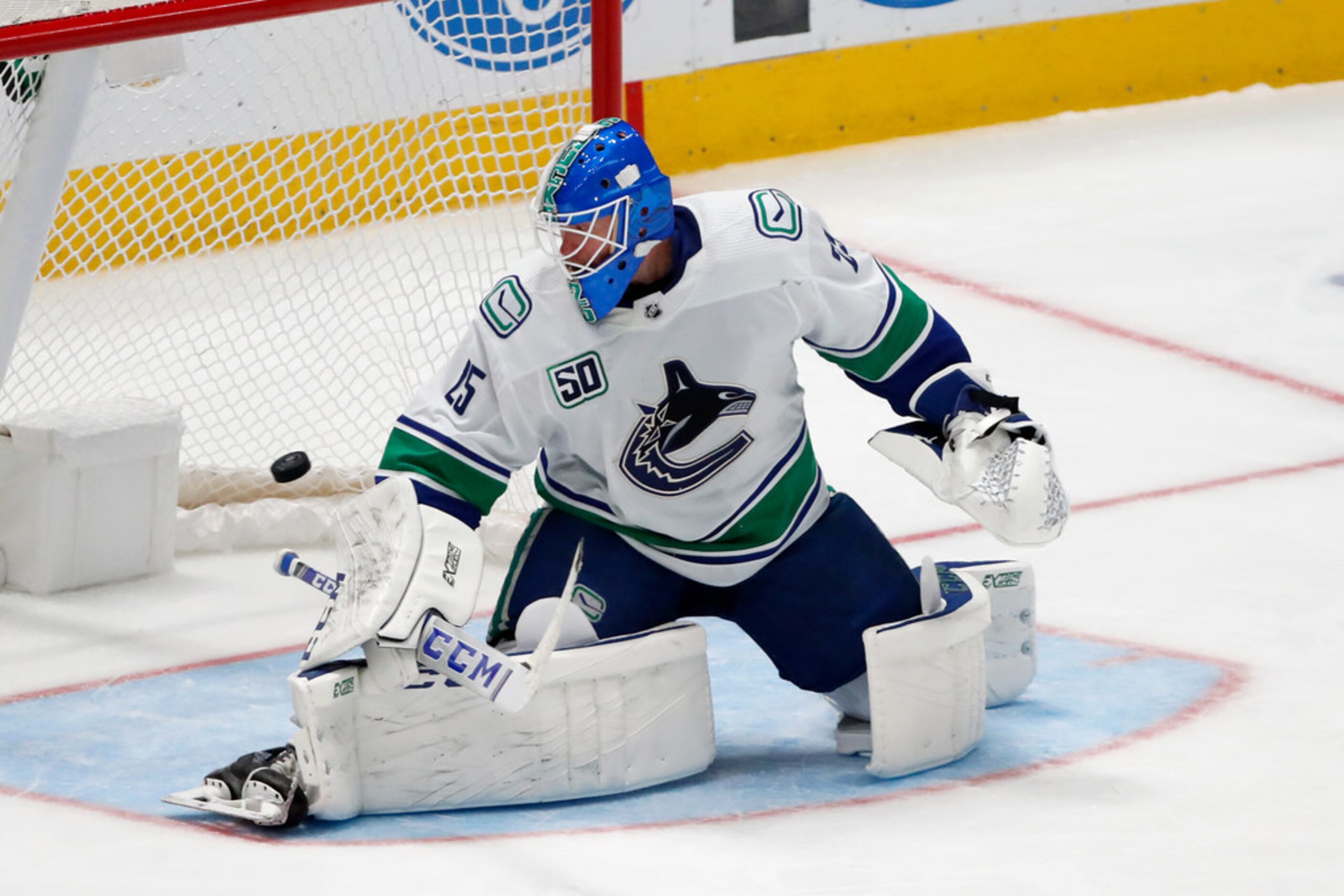 Vancouver Canucks goaltender Jacob Markstrom (25) looks back to see the puck reach the back...