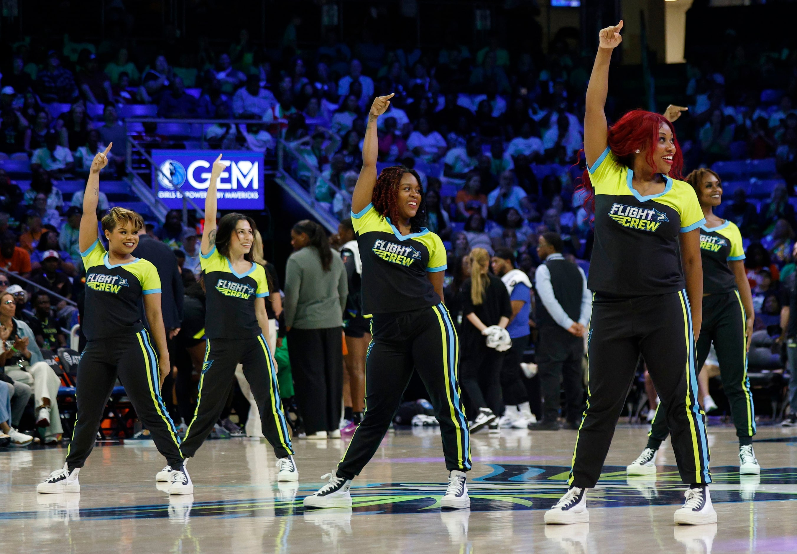 The Dallas Wings Flight Crew members perform during a timeout in the second half of a WNBA...