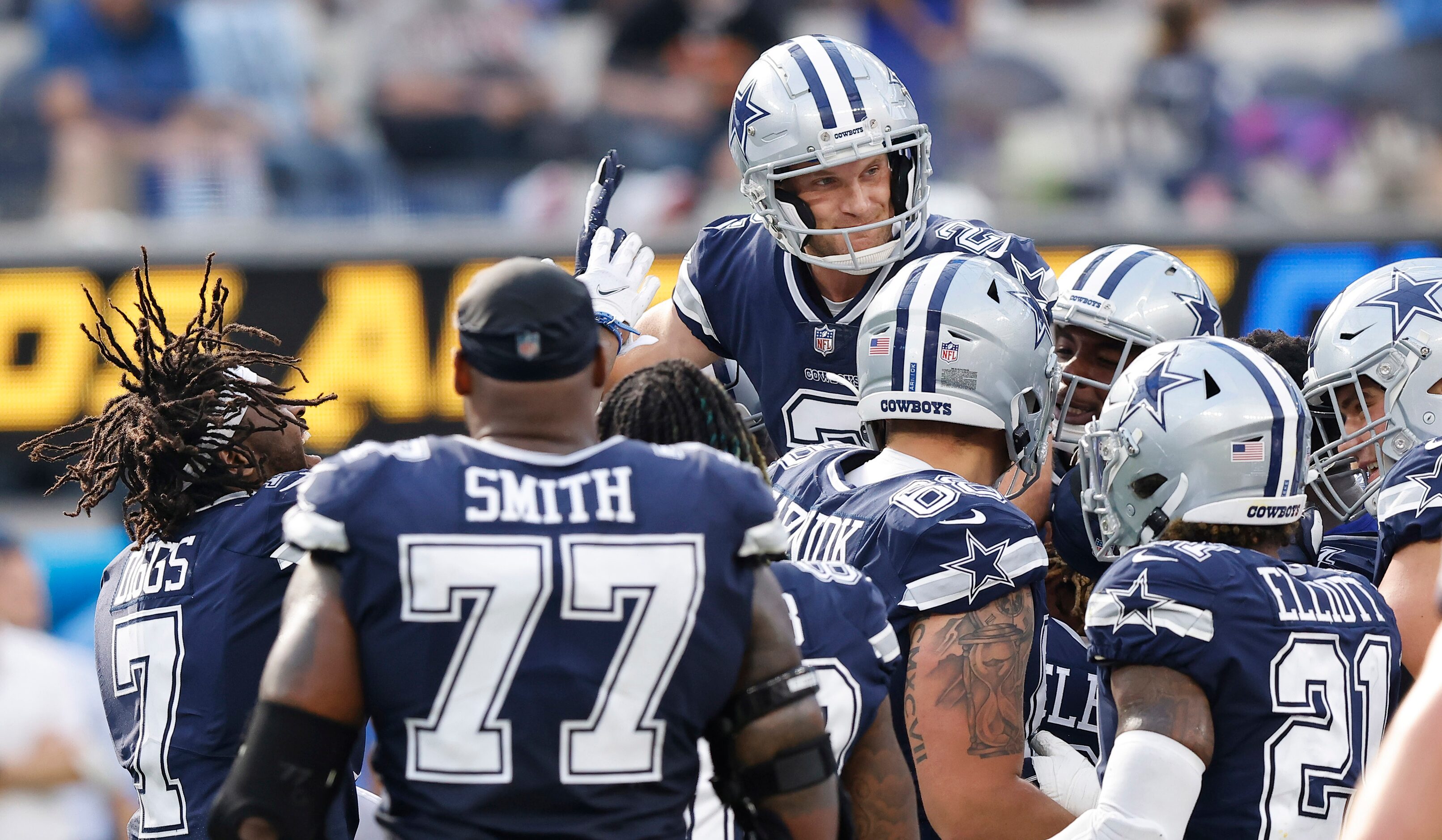 Dallas Cowboys place kicker Greg Zuerlein (2) lifted into the air and congratulated by...