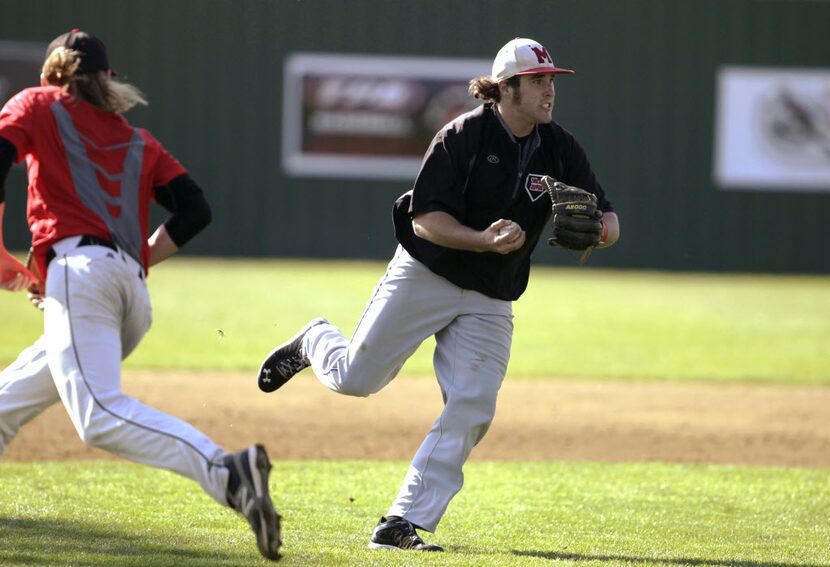 Flower Mound Marcus' third baseman Brendan Venter looks to throw to first base during...