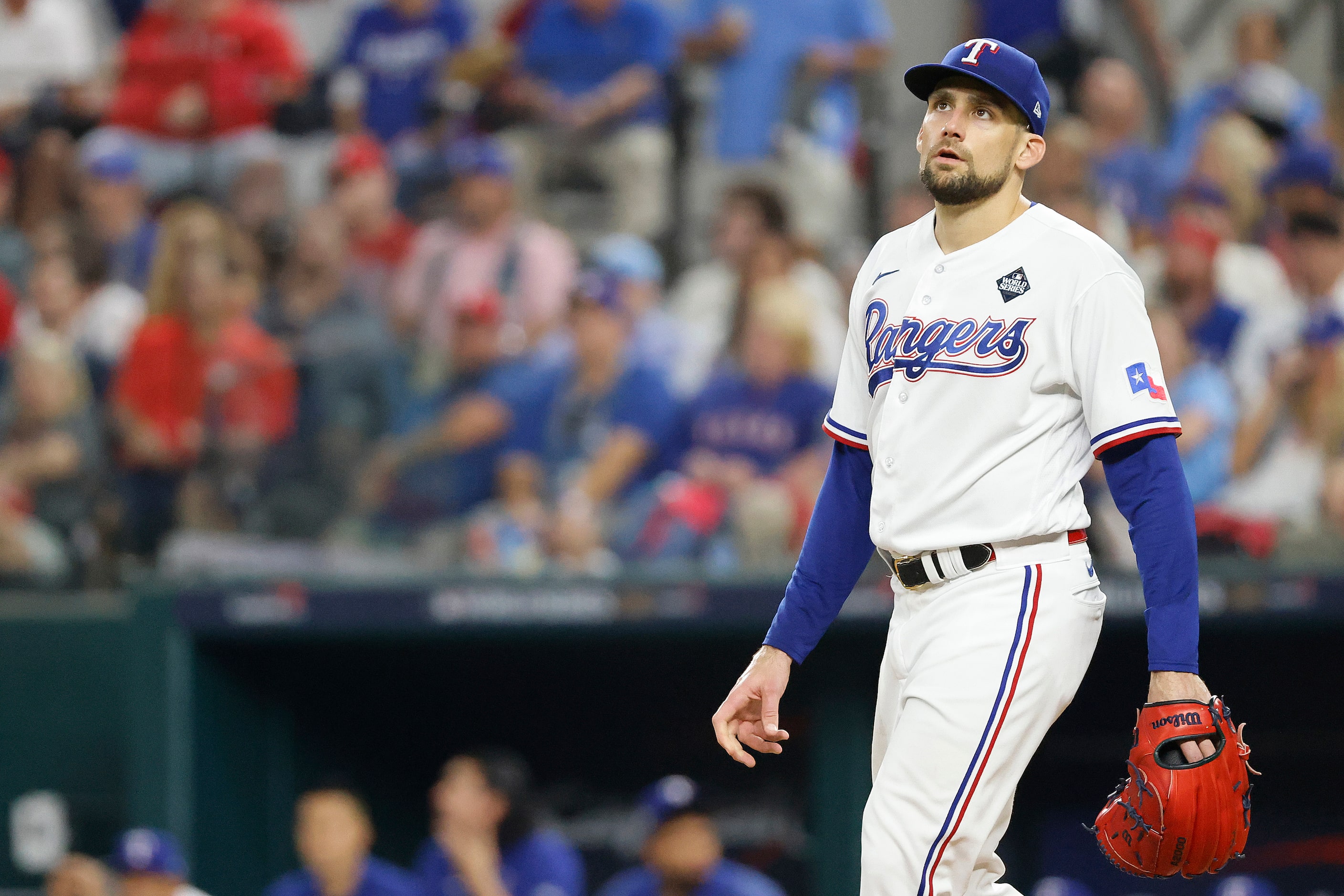 Texas Rangers starting pitcher Nathan Eovaldi reacts after giving up an RBI double to...