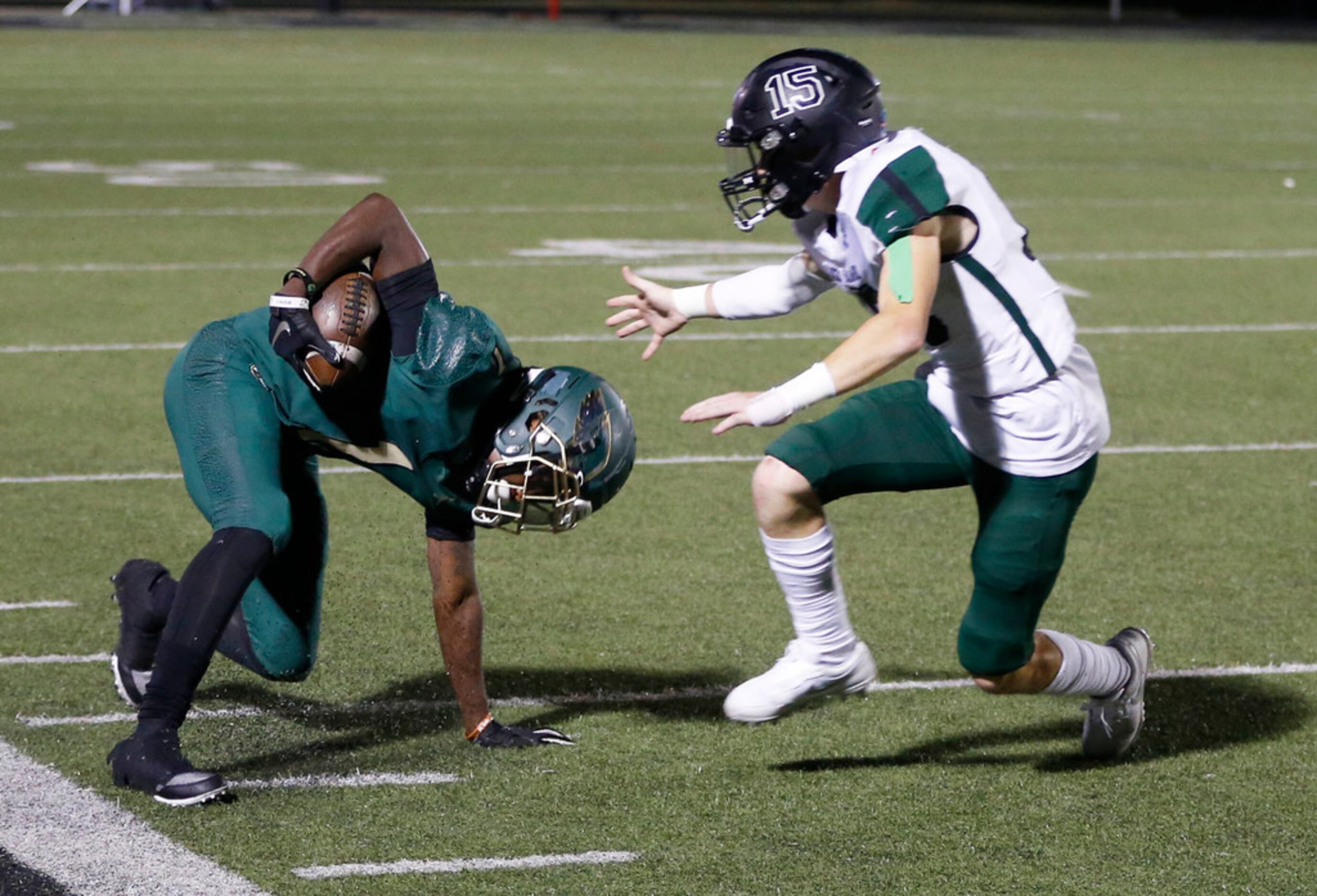 DeSoto Eagles Jordan Brown (1) keeps his feet in bounds as he turns in to pass Mansfield...