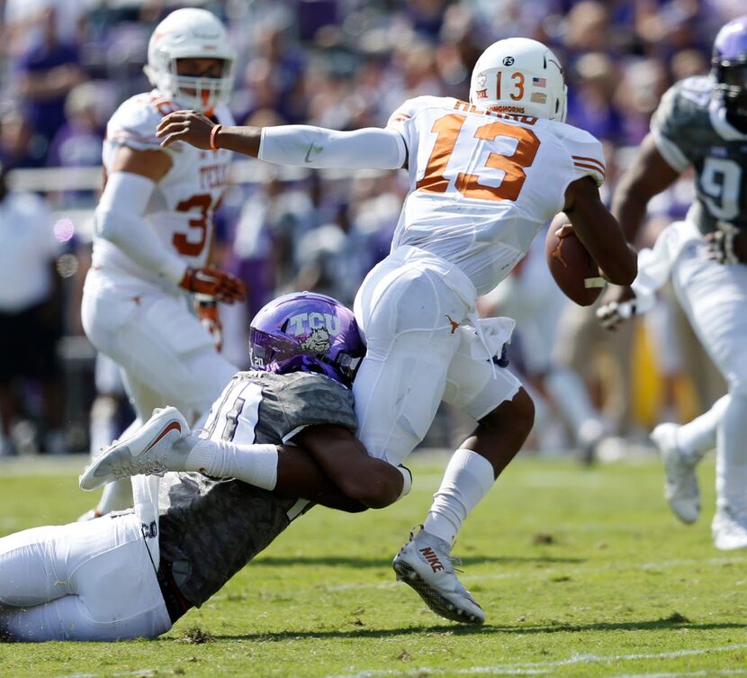 Texas Longhorns quarterback Jerrod Heard (13) is tackled by TCU Horned Frogs linebacker...