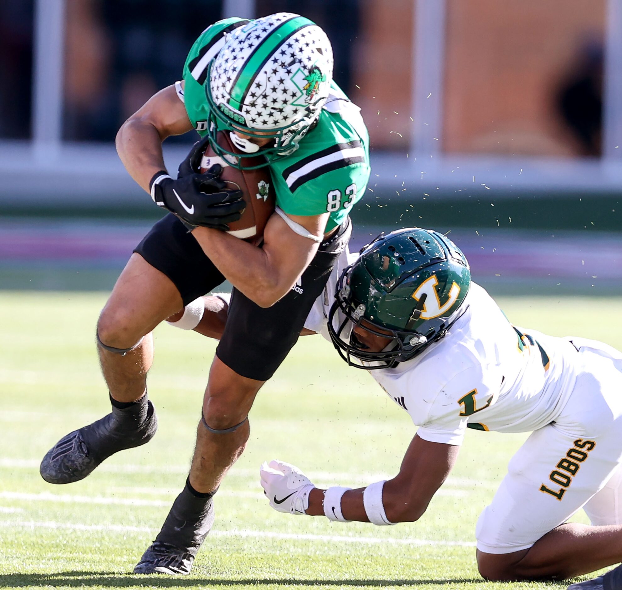 Southlake Carroll running back Christian Glenn (83) tries to break a tackle against Longview...