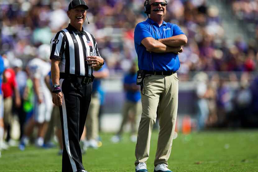 Southern Methodist Mustangs head coach Sonny Dykes reviews a play during the first quarter...