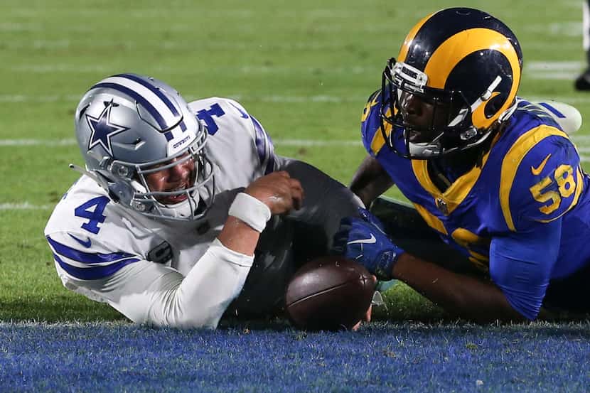 Dallas Cowboys quarterback Dak Prescott (4) scores a touchdown during the fourth quarter of...