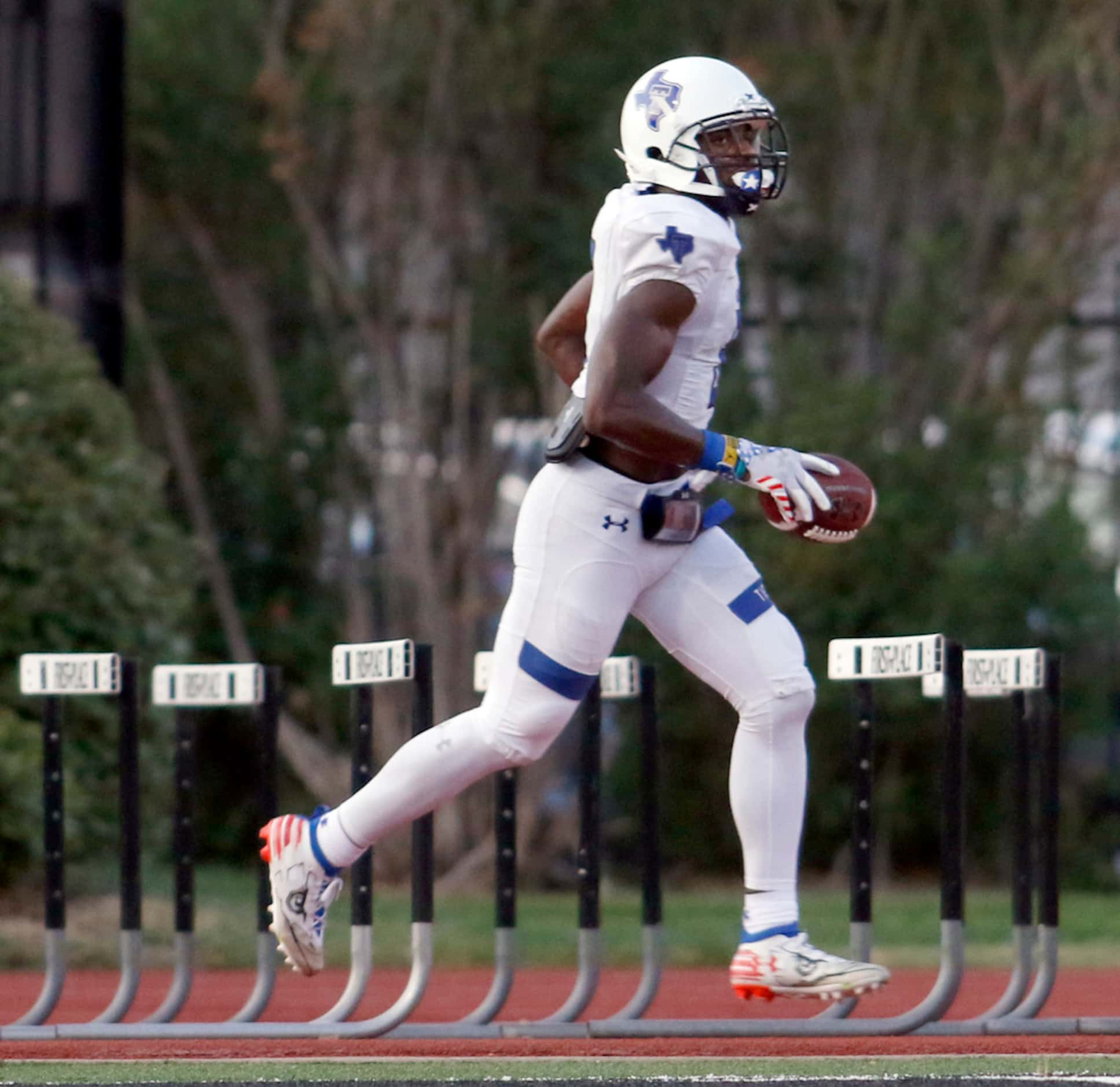 Trinity Christian-Cedar Hill receiver Marques Buford (8) strolls into the end zone with a...