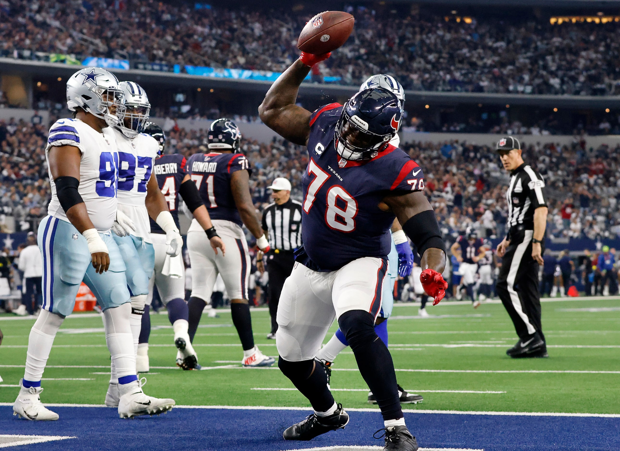 Houston Texans offensive tackle Laremy Tunsil (78) spikes the football after it being given...