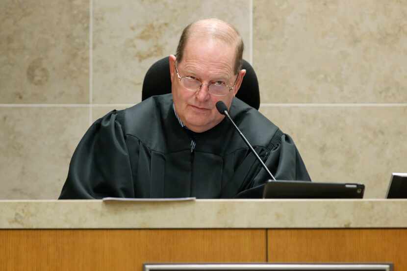 District Judge Mark Rusch addresses the court during the trial of Enrique Arochi in...