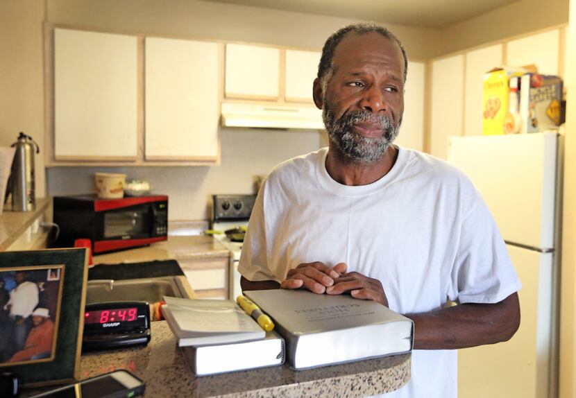 Harvey Pollard, with his Bibles, in his tidy Eban Village apartment