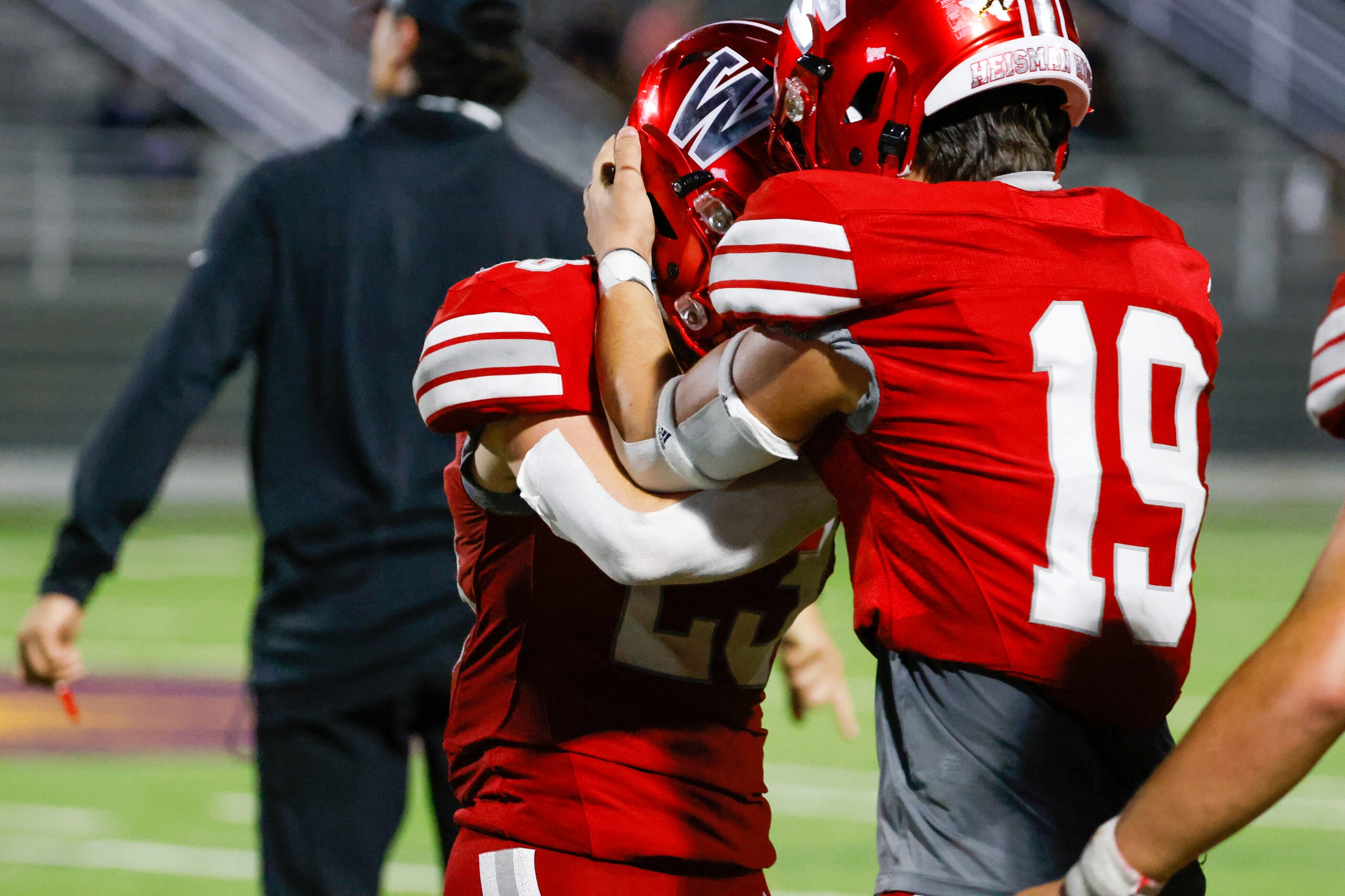 Woodrow Wilson defensive back Riley Adams (23) knocks helmets with defensive back Jacob...