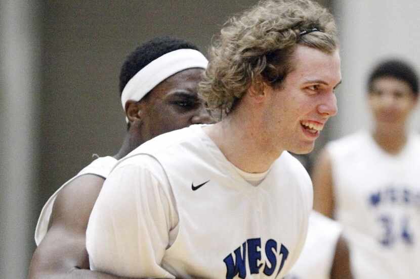 Plano West seniors Soso Jamabo, left, and Mickey Mitchell celebrate a 49-43 win over Cedar...