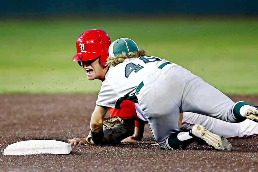 Mansfield Legacy's Sam Mahofski (left) struggles to touch the plate as he is tagged out by...