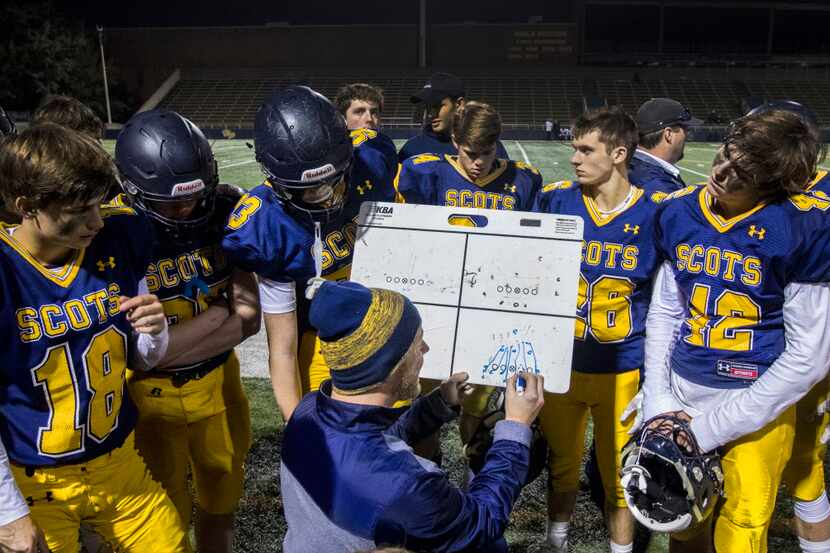 Coach Stephen Byrd talks to players during the first half of the junior varsity high school...