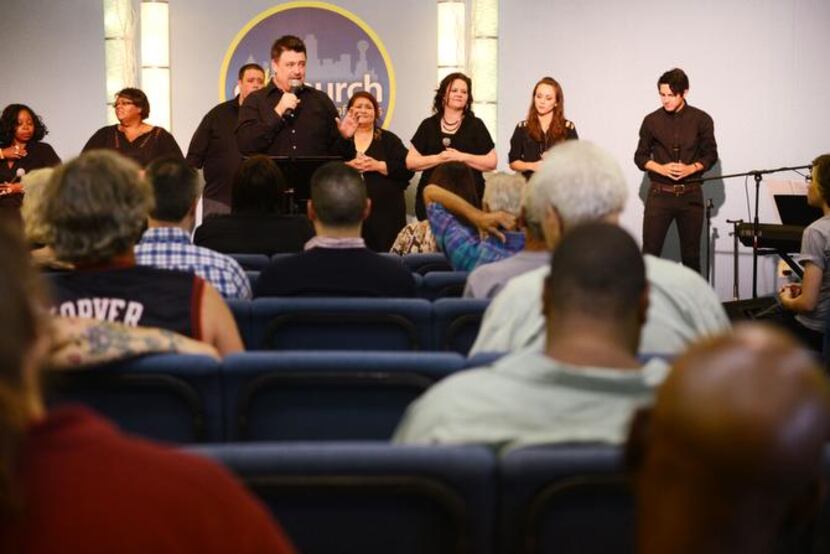 
Pastor Jeff Ferguson leads a service for the congregation, which includes the homeless from...