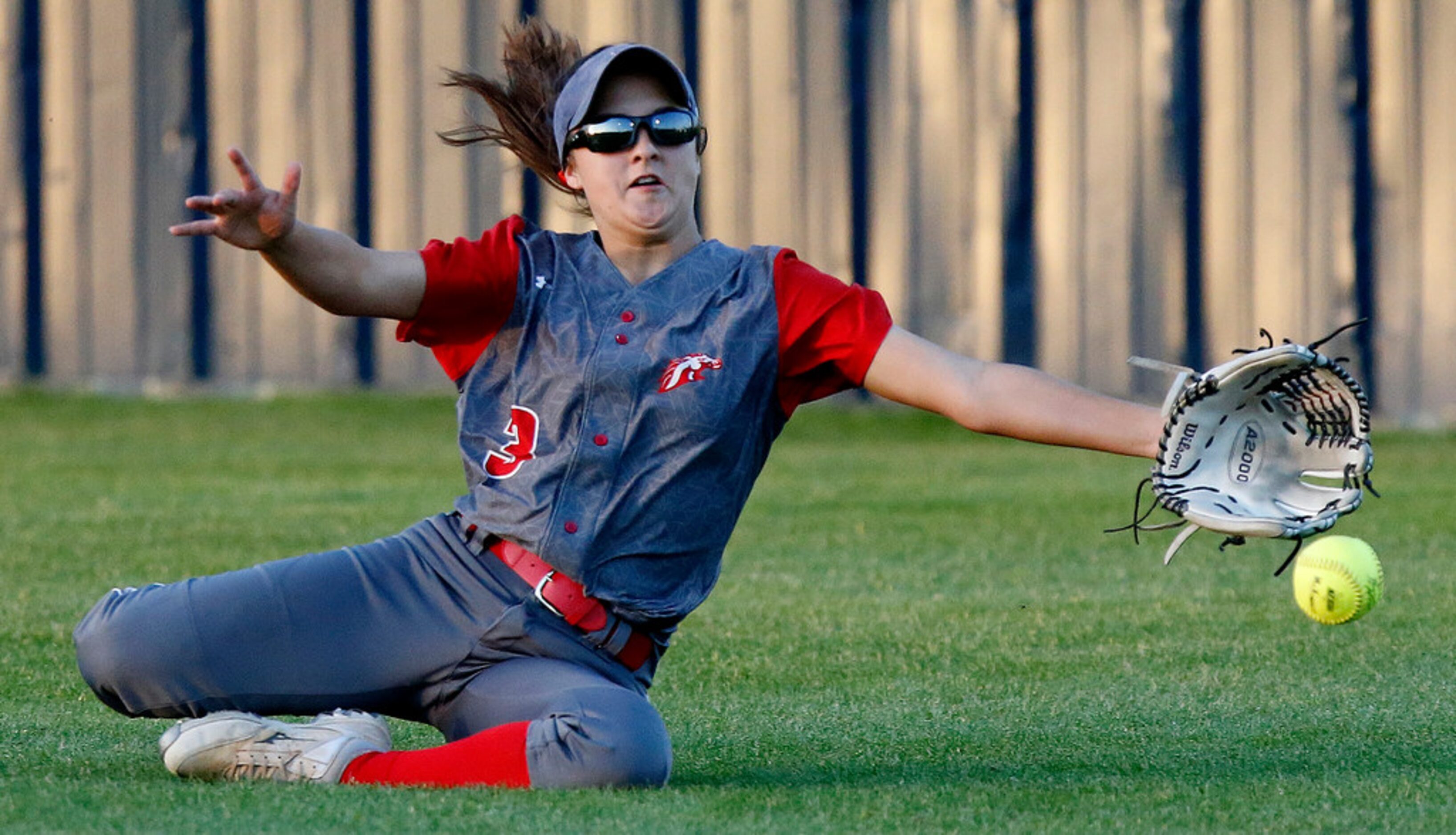 McKinney Boyd High School center fielder Katy Loera (3) was unable to make the catch during...