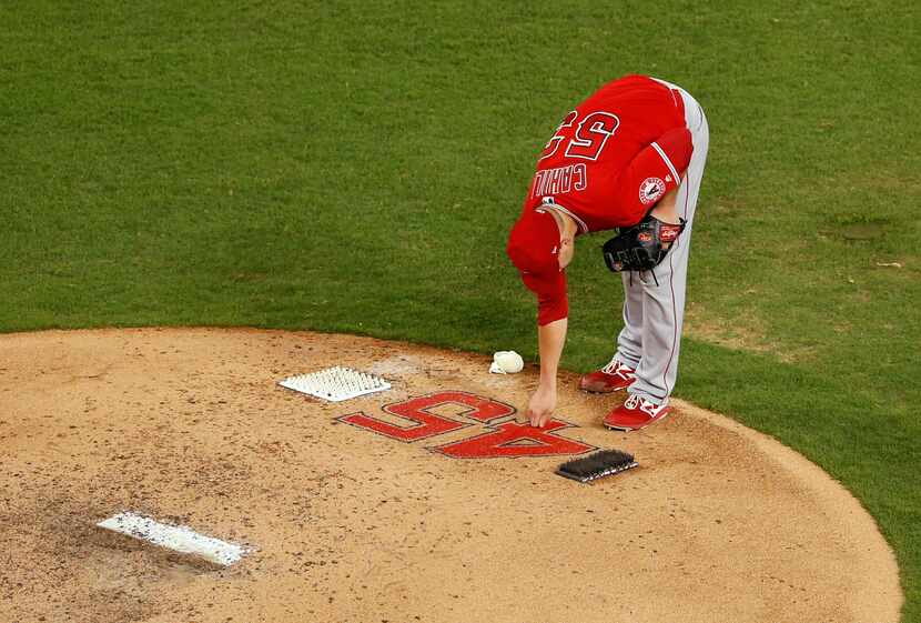 Los Angeles Angels pitcher Trevor Cahill (53) touches the number of Los Angeles Angels Tyler...