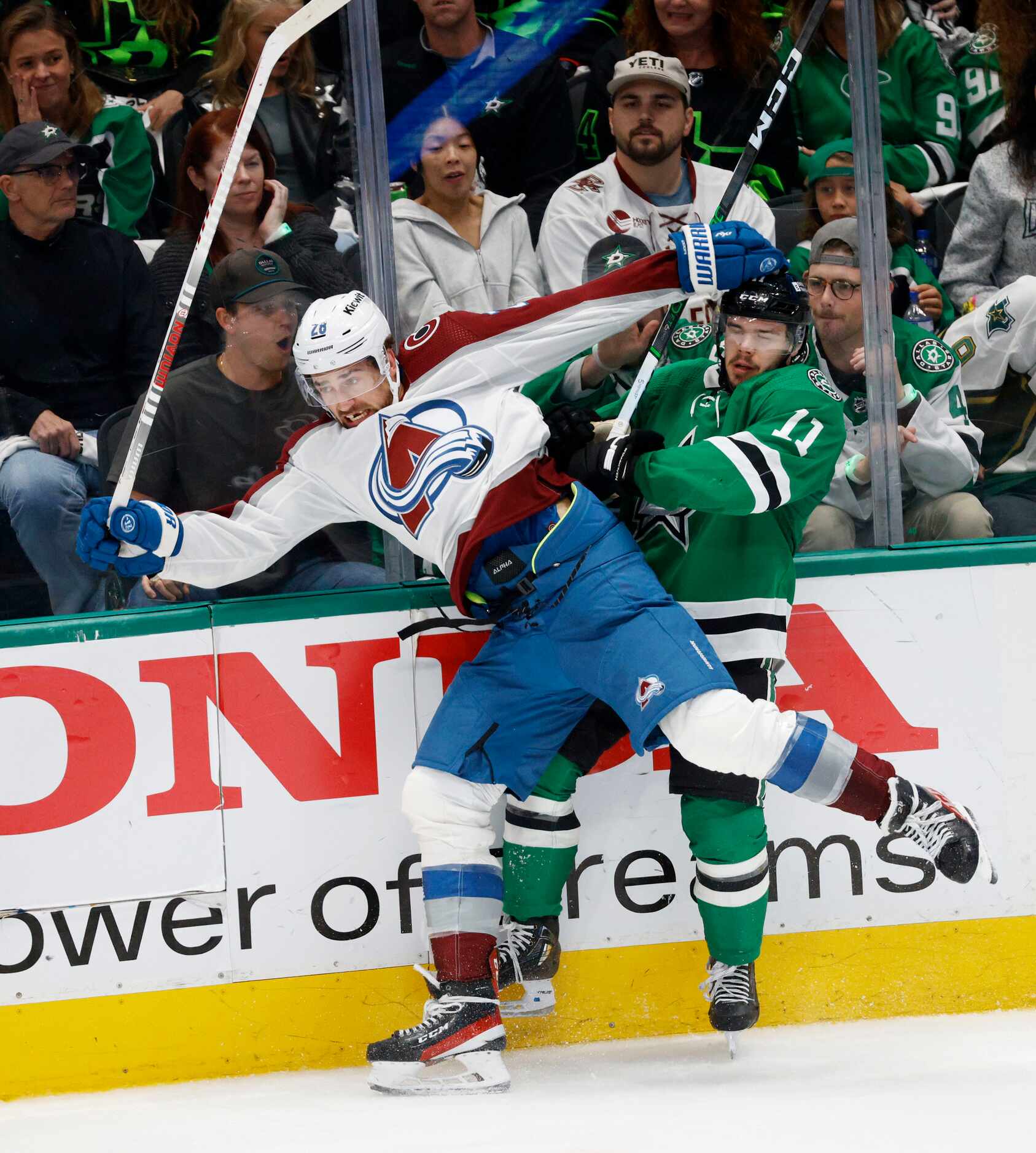 Colorado Avalanche left wing Miles Wood (28) tangles with Dallas Stars center Logan...