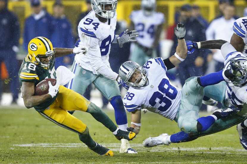 Green Bay Packers wide receiver Randall Cobb (18) avoids the collision by Dallas Cowboys...