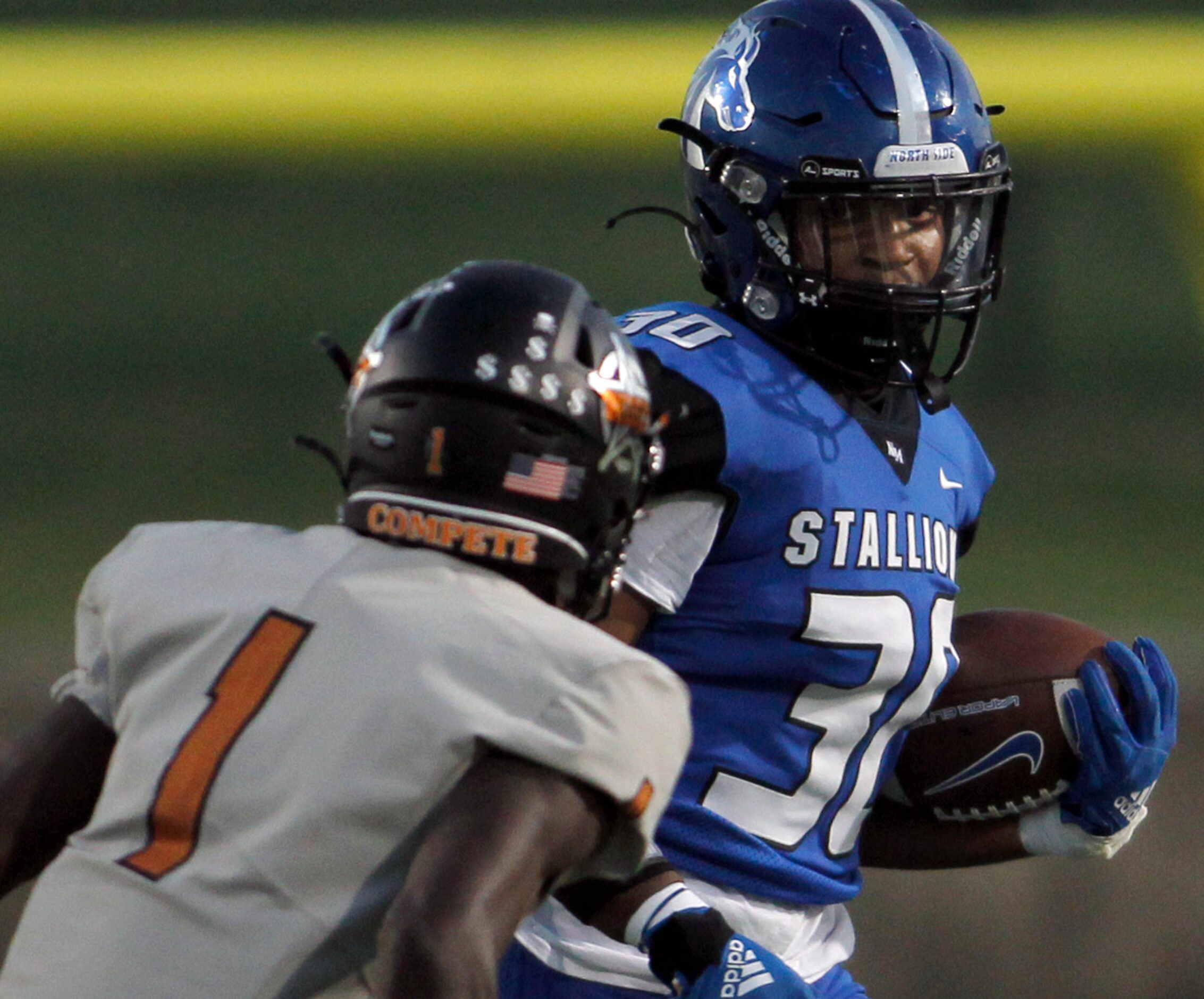 North Mesquite running back Michael Gibson (30) eyes the defense of West Mesquite's Dylan...