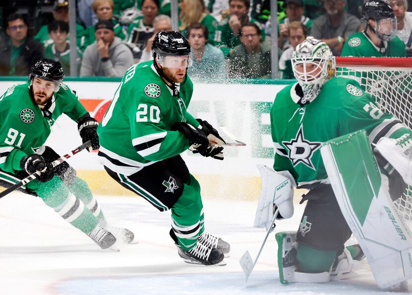 Dallas Stars defenseman Ryan Suter (20) and center Tyler Seguin (91) skate hard into the net...