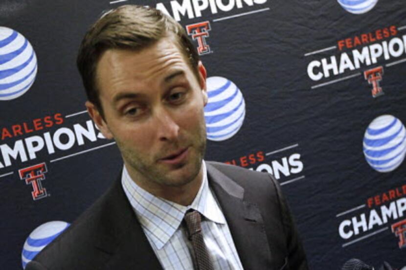 New Texas Tech coach Kliff Kingsbury talks with reporters at Lubbock International Airport...