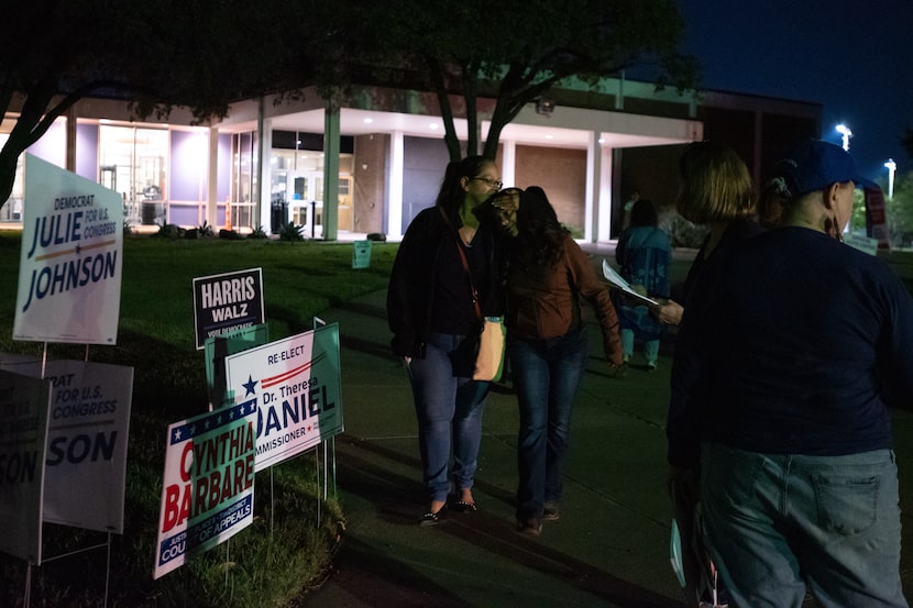 Linda Ovalle, 47, kisses her daughter Nancy Escalera, 15, as the two women walk together...