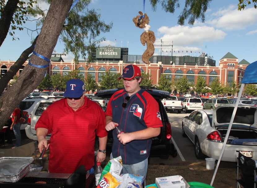 Steve Wilhelms and Bryan Wilhelms, of Rockwall,  tailgate under a hanging Rally Squirrel (a...