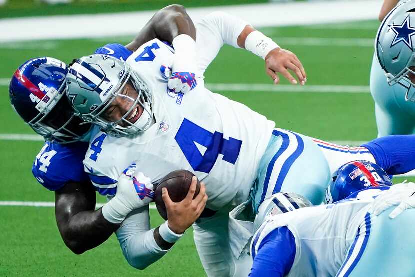 Dallas Cowboys quarterback Dak Prescott (4) is sacked by New York Giants linebacker Markus...
