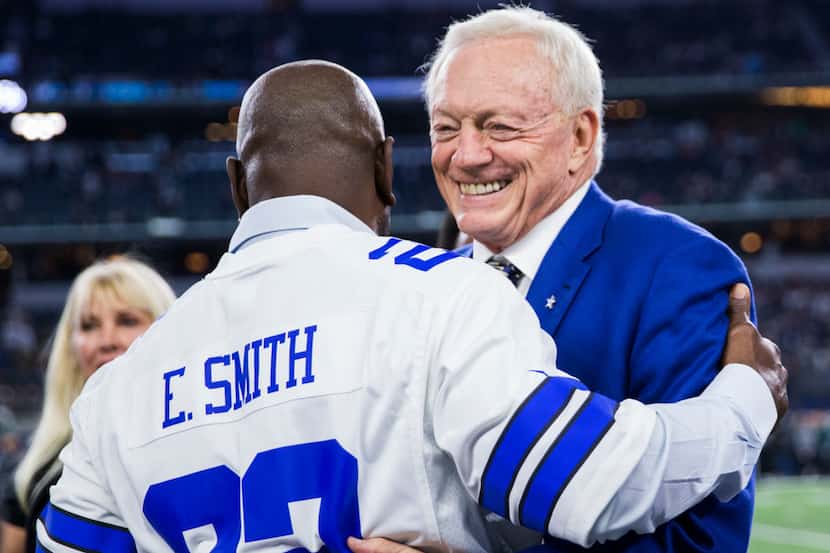 Dallas Cowboys owner Jerry Jones gets a hug from former Dallas Cowboys running back Emmitt...