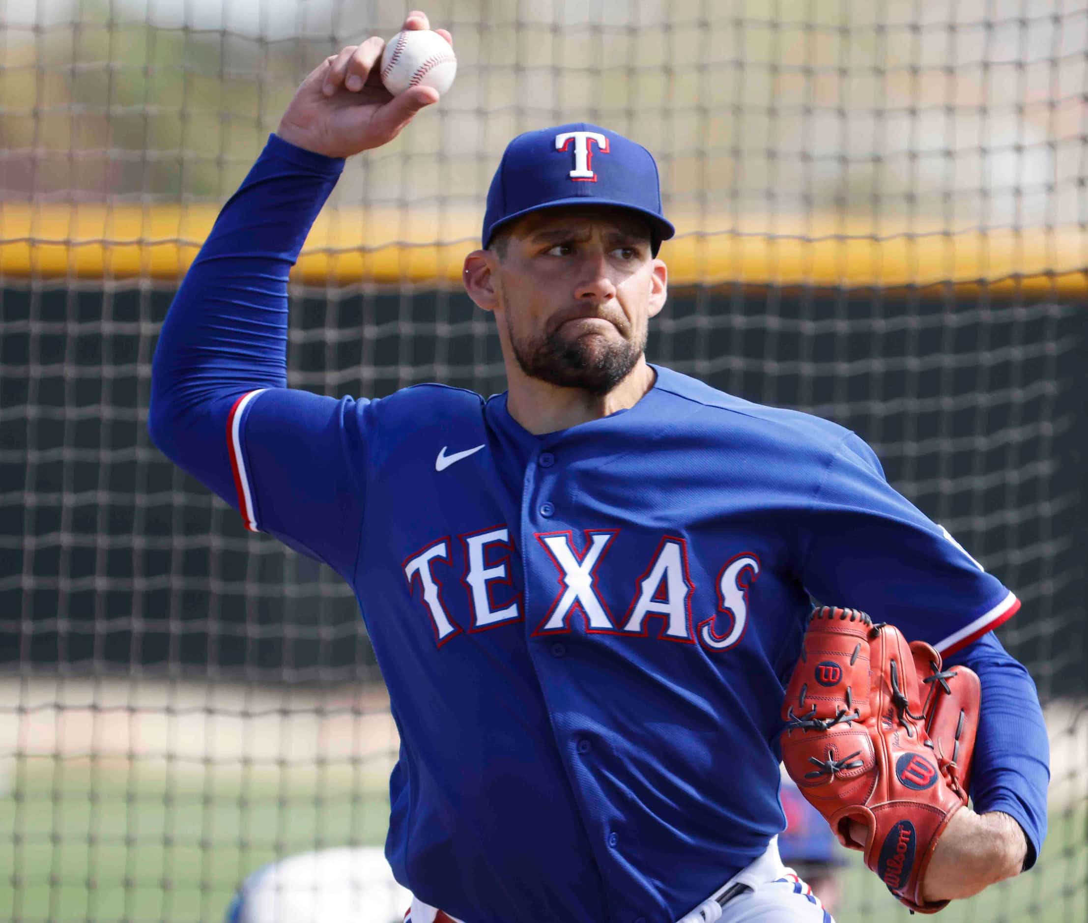 Texas Rangers pitcher Nathan Eovaldi throws a pitch during a spring training workout at the...