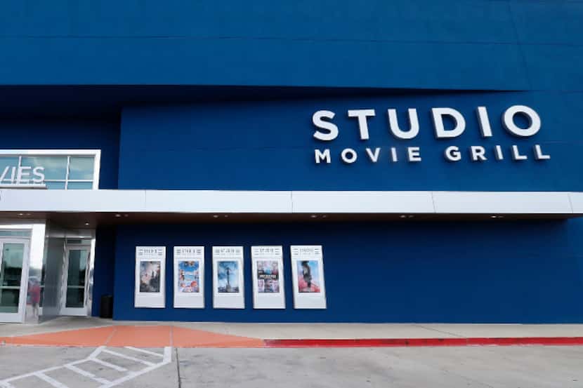 People walk into the Studio Movie Grill in The Colony, Texas, Friday, Sept. 23, 2016. The...