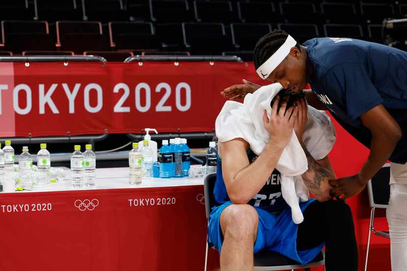 Slovenia’s Luka Doncic (77) sits dejected as France’s Frank Ntilikina (1) speaks to him...