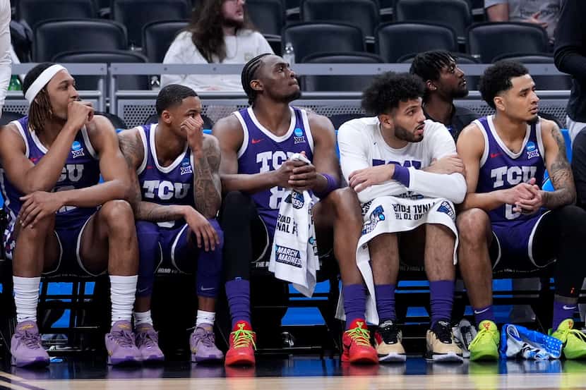 TCU players watch from the bench in the second half of a first-round college basketball game...