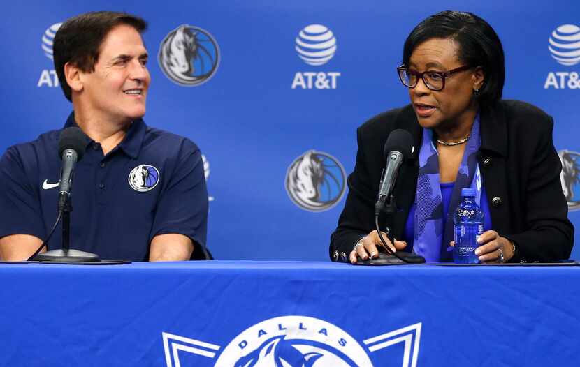 Dallas Mavericks owner Mark Cuban, left, looks on as Cynthia Marshall, new interim CEO of...