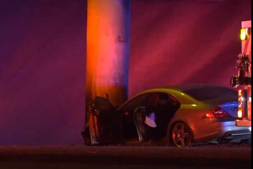 A car lies against a concrete pillar after it crashed during a police chase involving a...