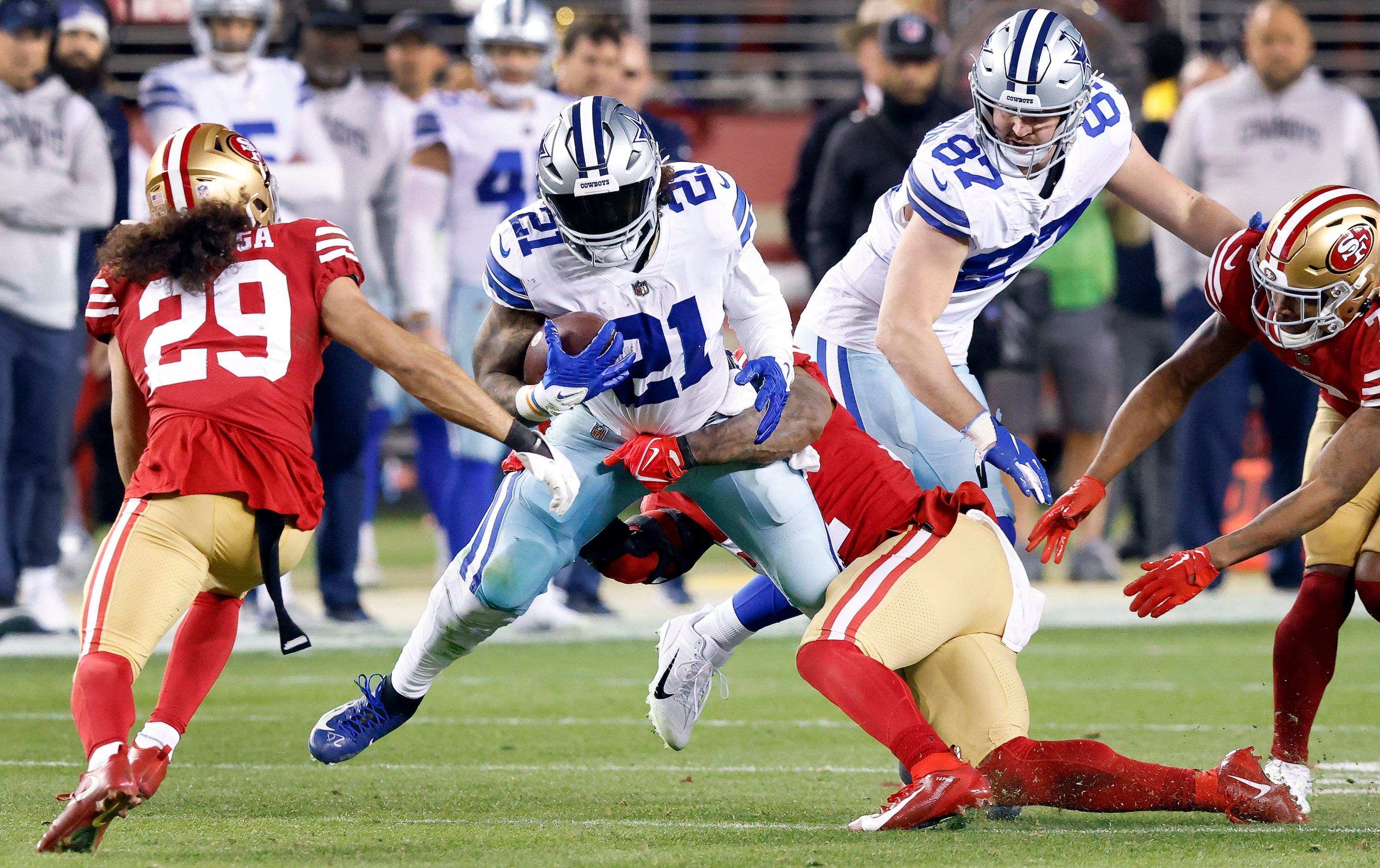 Dallas Cowboys running back Ezekiel Elliott (21) is tackled in the fourth quarter by San...