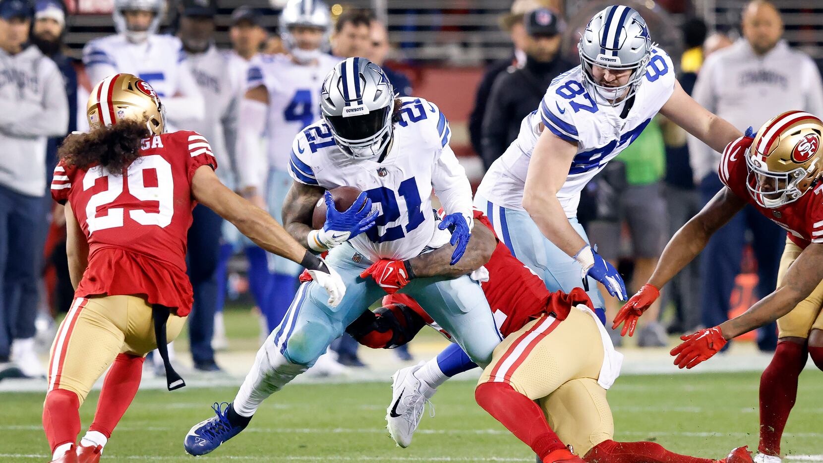 Dallas Cowboys running back Ezekiel Elliott (21) is tackled in the fourth quarter by San...