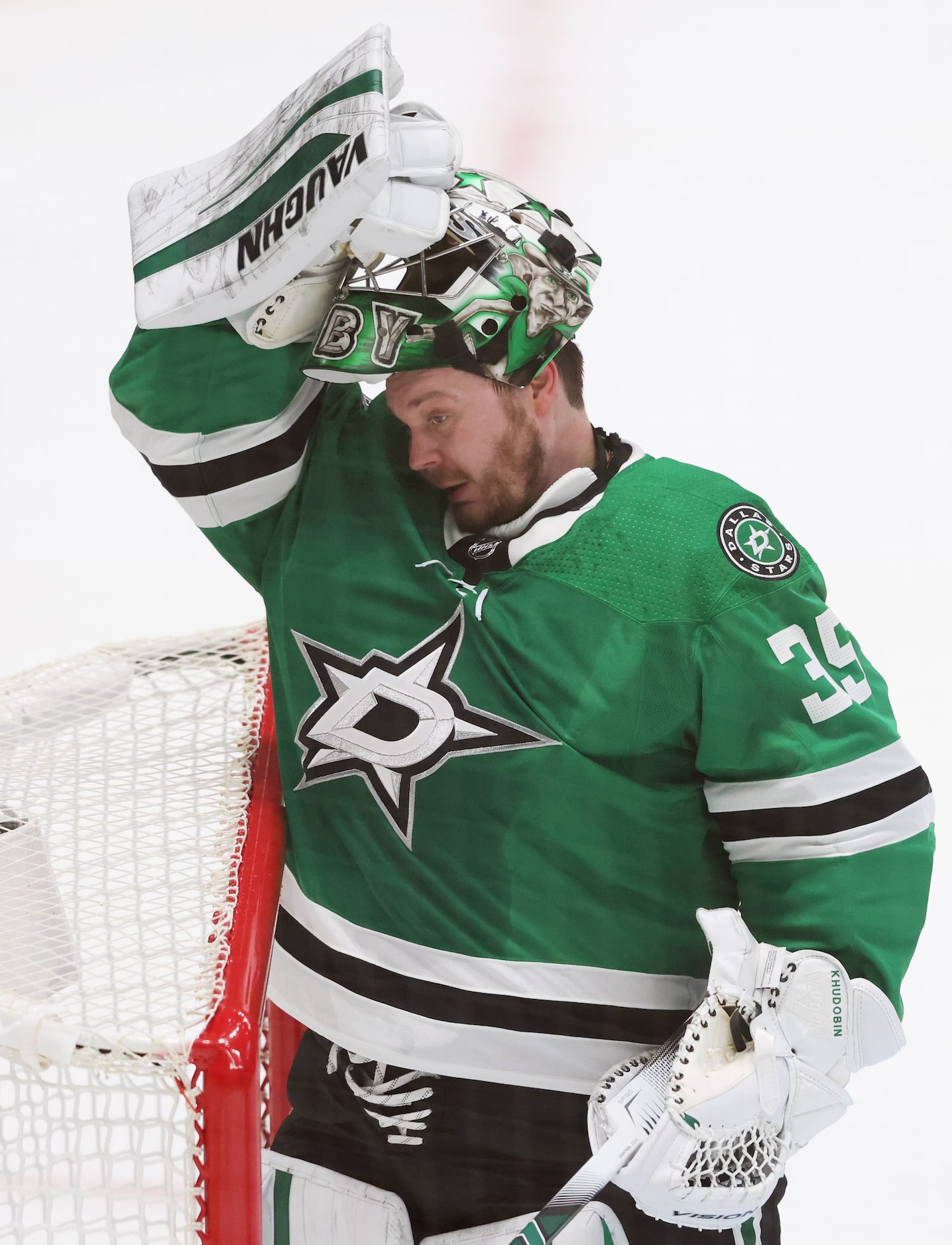 Dallas Stars goaltender Anton Khudobin (35) puts his mask back on in a game against the...