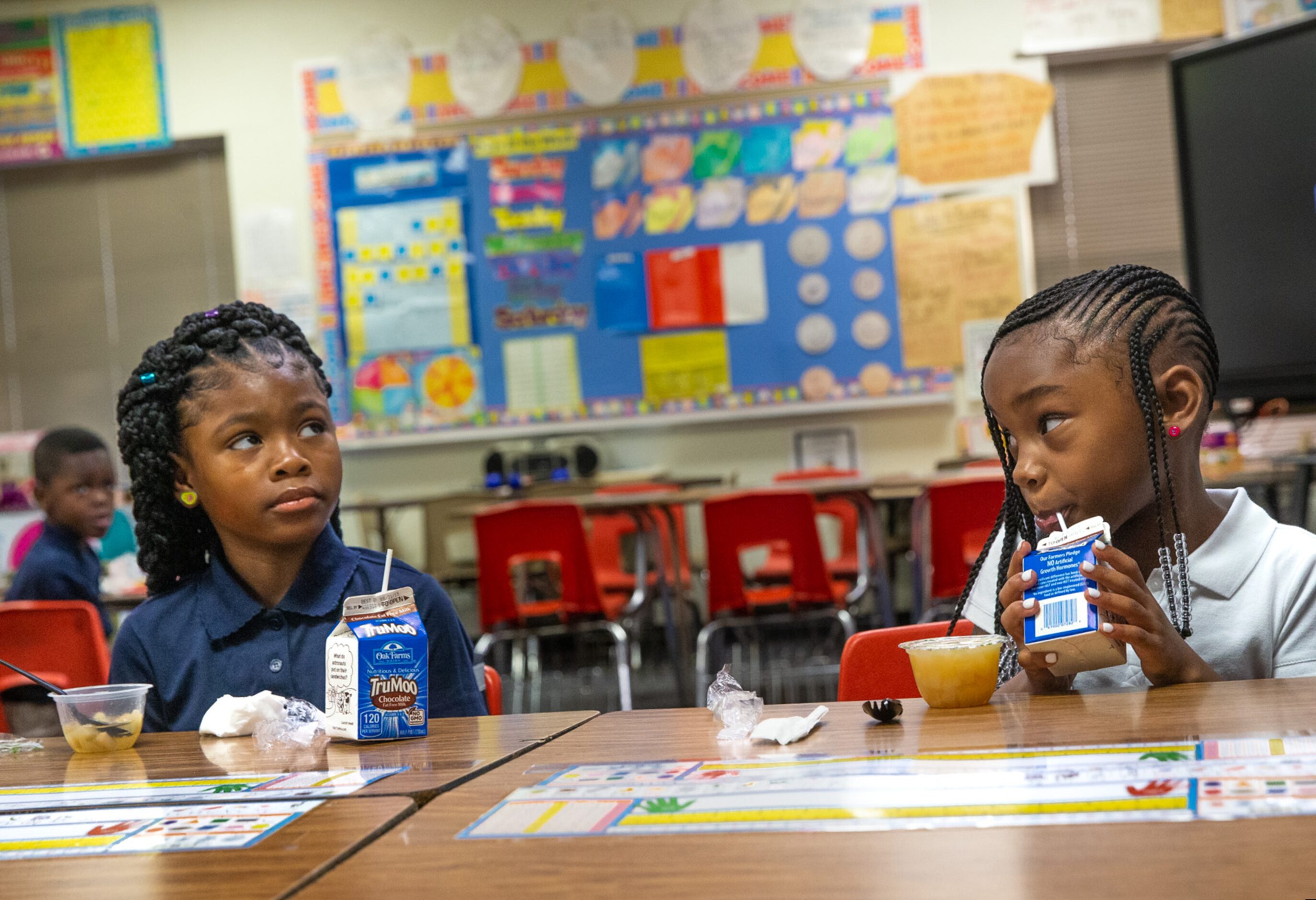 Azaria Ross, 6 (left), and Money Lucky, 6 (right), eat breakfast at Martin Luther King Jr....