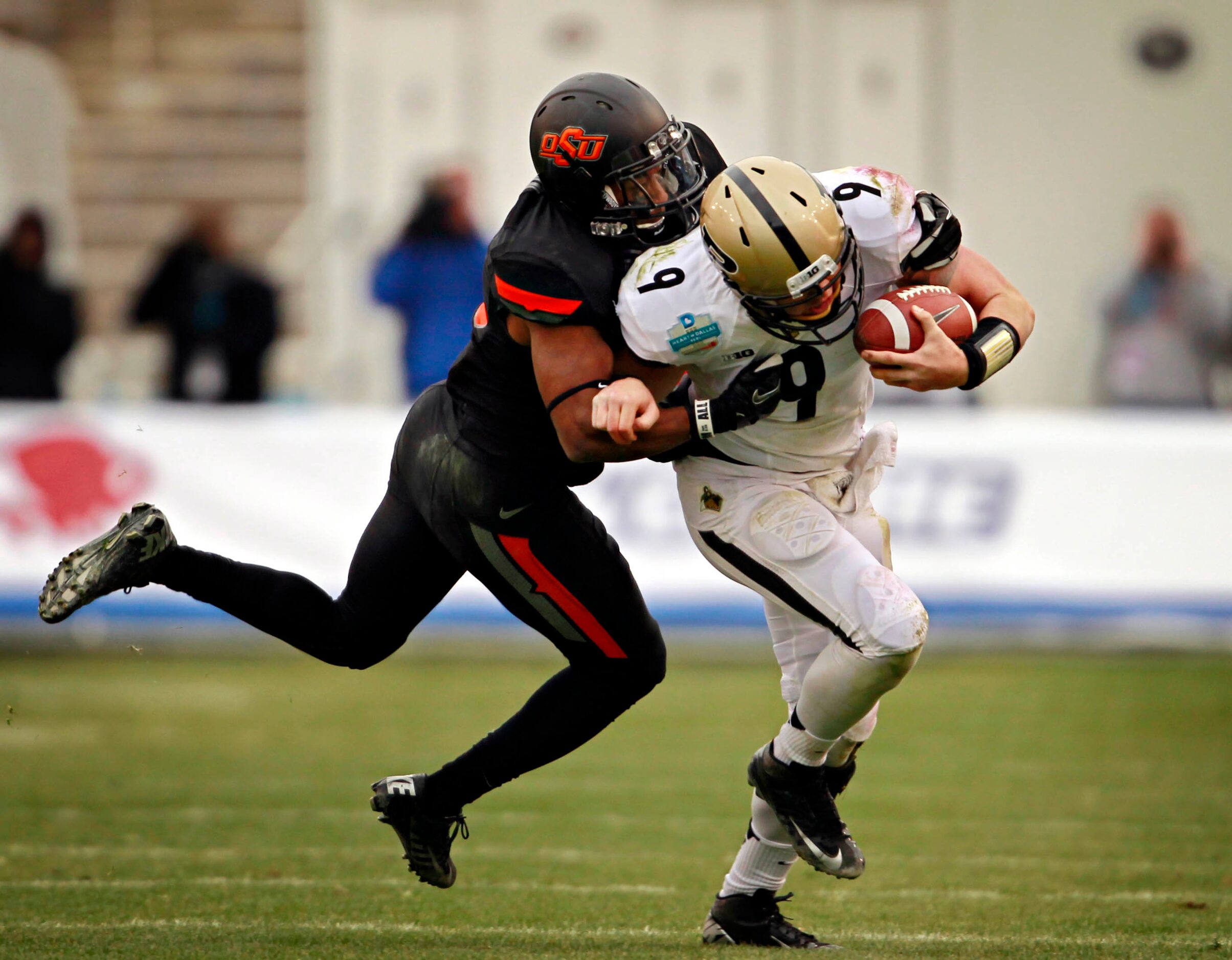 Oklahoma State Cowboys cornerback Brodrick Brown (19) sacks Purdue Boilermakers quarterback...