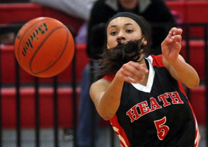 Rockwall-Heath's Alexa Hoy (5) gets  whipped in the face by her own hair  as she made a pass...