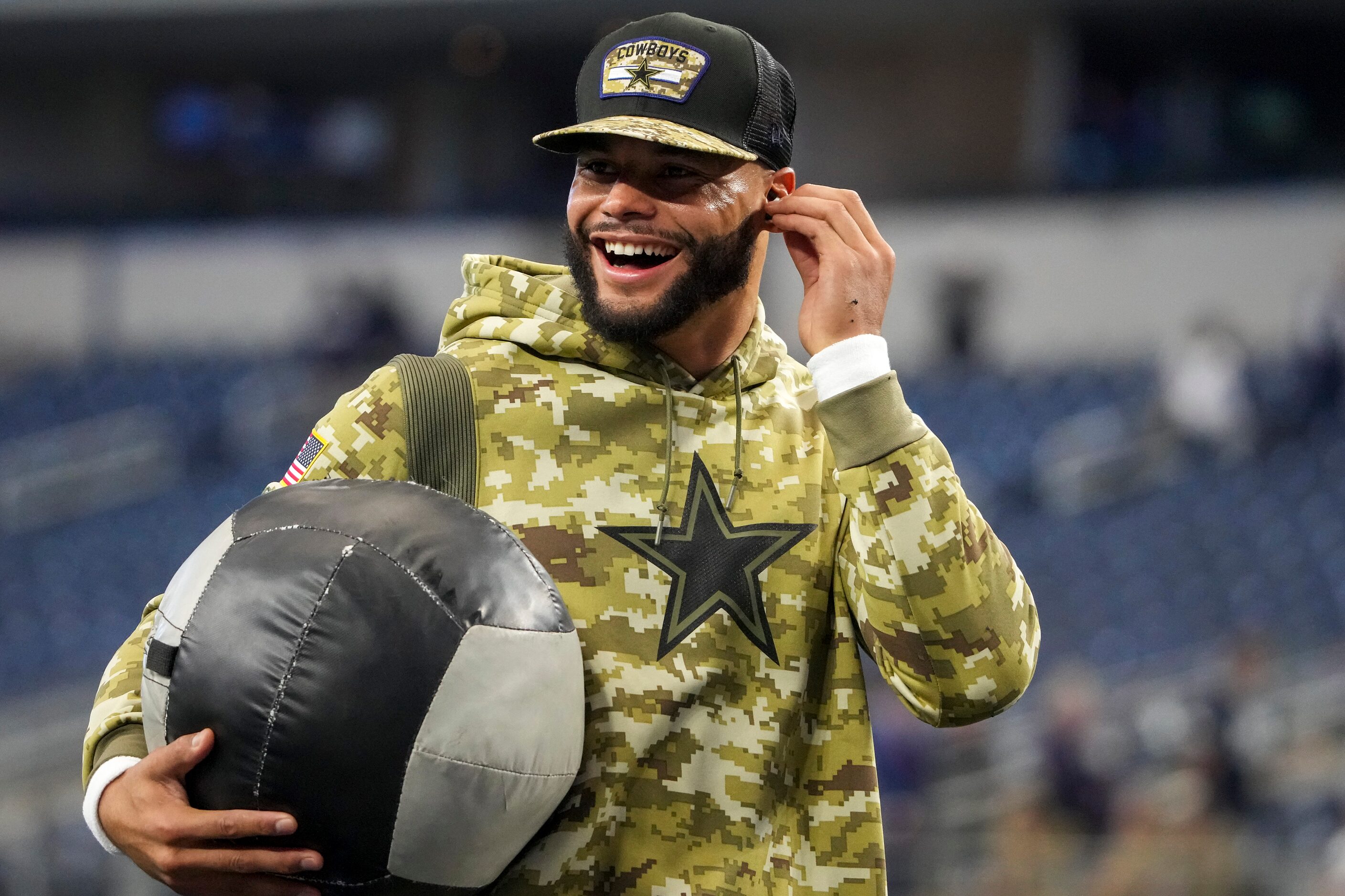 Dallas Cowboys quarterback Dak Prescott stretches before an NFL football game against the...