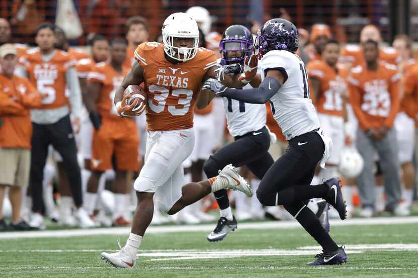 Texas running back D'Onta Foreman (33) is pursued by TCU safety Nick Orr (18) on a 44-yard...