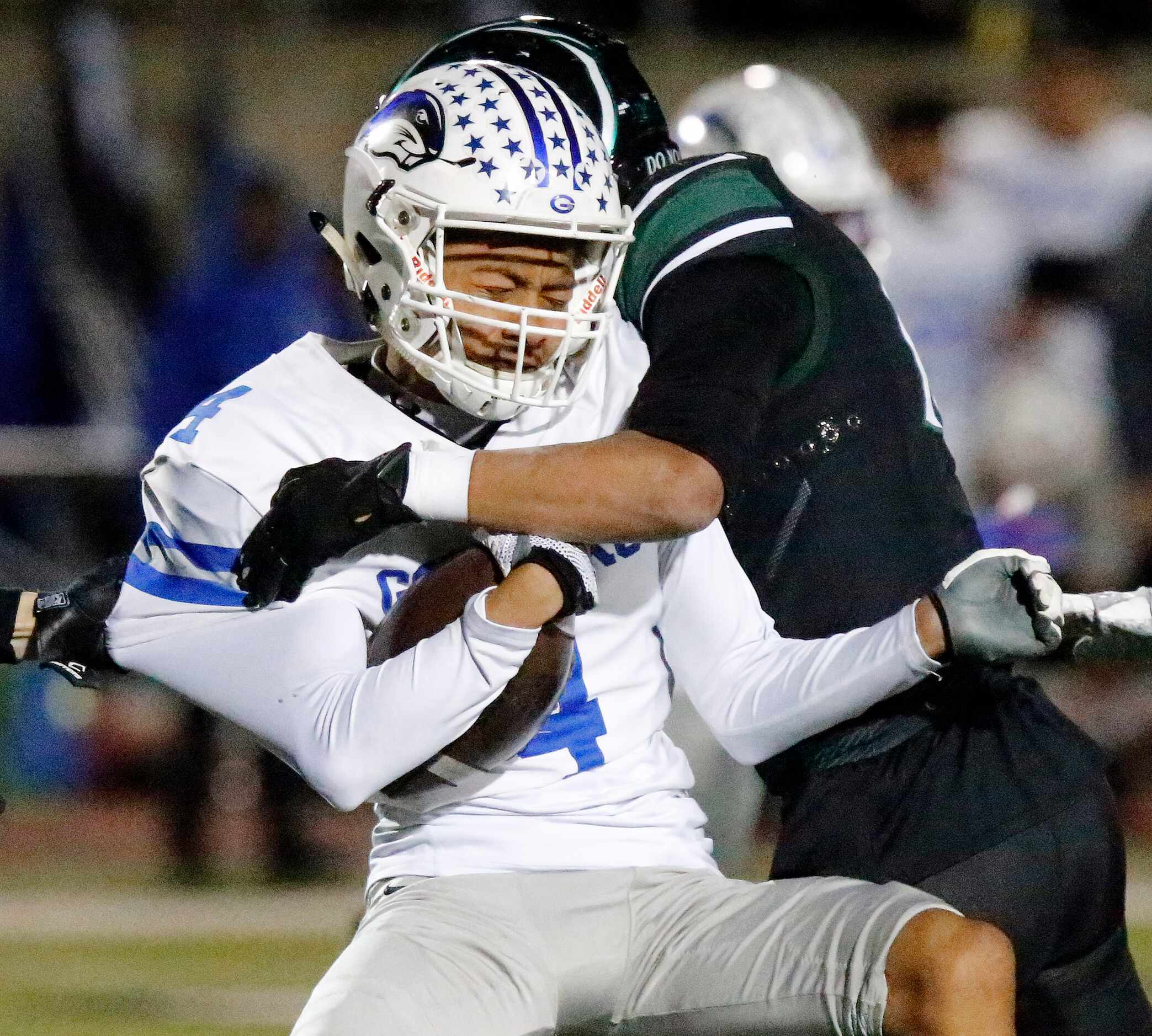 Grand Prairie High School kick returner Sergio Rodriguez (4) is hit by Prosper High School’s...